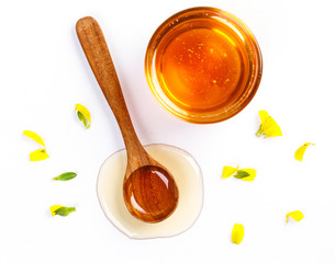 Honey with jar and honey spoon and folwer isolated on white background