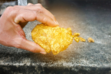 Big pure gold ore found in the mine on hand. A lump of gold.