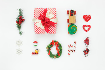 Flat lay aerial image of decorations & ornaments Merry Christmas & Happy New Year concept.Festive decor for winter season.Essential accessories objects on modern classic wooden white background.