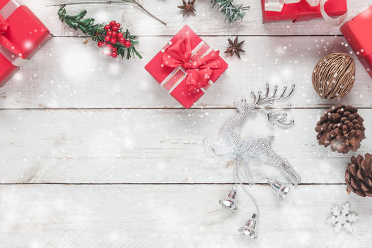 Aerial view image of Merry Christmas decorations & Happy New Year ornaments concept.Crystal reindeer with essential items festive holidays.snowflakes fall design with objects on wood white background.