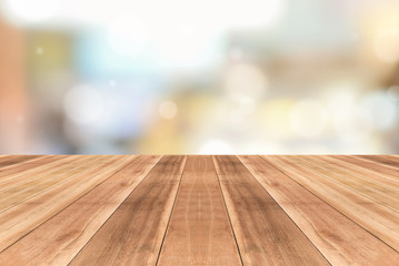Wooden table top against blurred cafe background