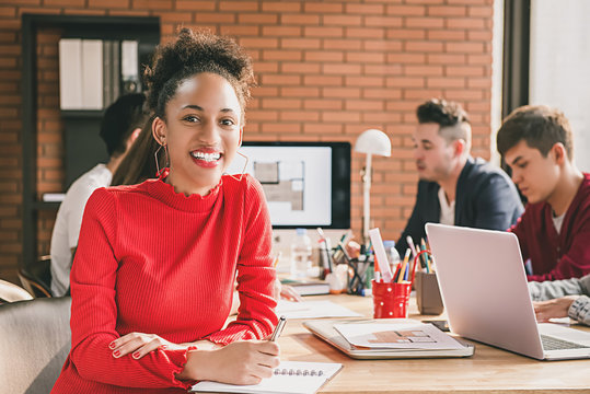 Black business woman in casual red top at office meeting