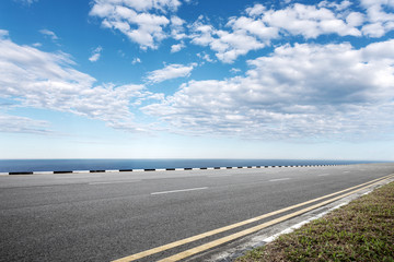 Fototapeta premium empty asphalt road with blue sea in blue sky