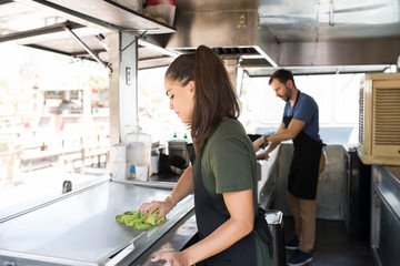 Woman cleaning a food truck
