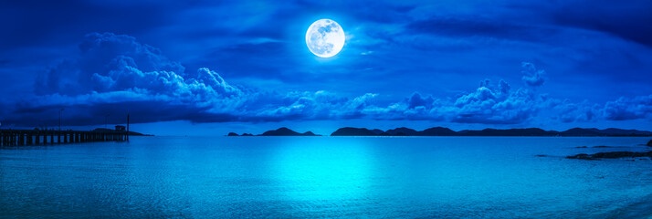 Panorama of sky with full moon on seascape to night.