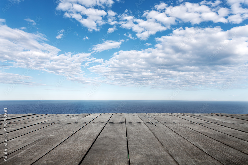 Wall mural empty wooden floor with beautiful sea in blue cloud sky