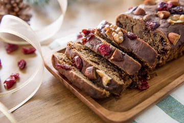Beautiful tasty homemade mixed nut dried fruit cake on wooden table