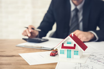 Businessman calculating budget before signing real estate project contract