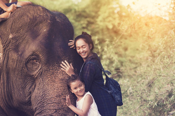 The smiling girl embraces an elephant