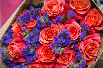 Fototapeta na wymiar The girl the florist makes a bouquet of flowers. The florist does a bouquet.
