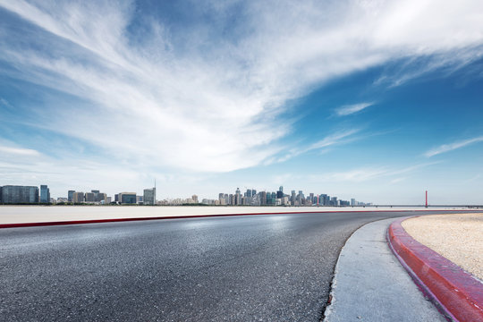 empty asphalt road with modern bridge and buildings