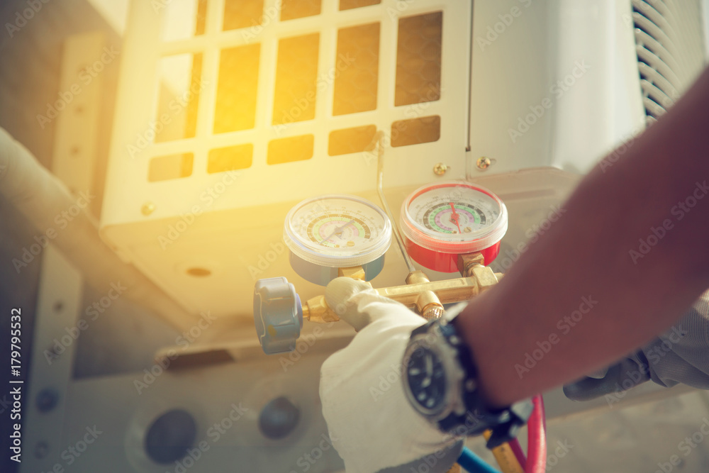 Wall mural Air Conditioning Technician and A part of preparing to install new air conditioner. manometers measuring equipment for filling air conditioners,gauges.