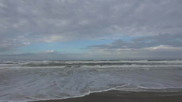 Waves rolling on the beach is a stormy day, winter mediterranean sea. Focene, Lazio, Italy. 4k