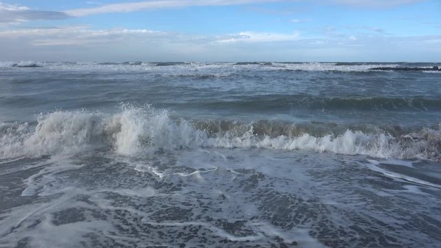 Waves rolling on the beach is a stormy day, winter mediterranean sea. Focene, Lazio, Italy. 4k