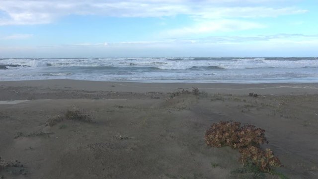 Waves rolling on the beach is a stormy day, winter mediterranean sea. Focene, Lazio, Italy. 4k