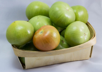 green tomatoes in a basket