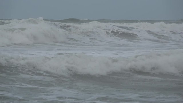 Waves rolling on the beach is a stormy day, winter mediterranean sea. Focene, Lazio, Italy. 4k