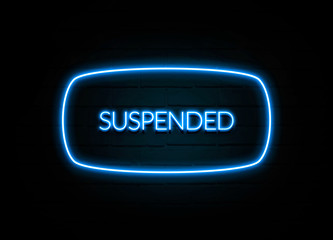 Suspended  - colorful Neon Sign on brickwall