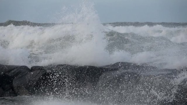 Waves rolling on the beach is a stormy day, winter mediterranean sea. Focene, Lazio, Italy. Slow motion