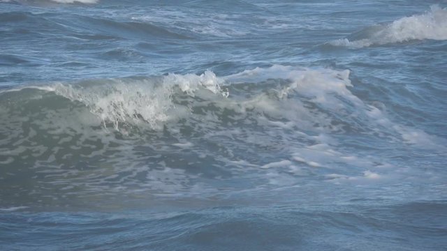 Waves rolling on the beach is a stormy day, winter mediterranean sea. Focene, Lazio, Italy. Slow motion