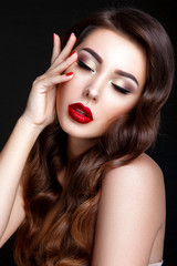 Beautiful woman portrait. Young lady posing close up on black background. Glamour make up, red lipstick, red nails. 