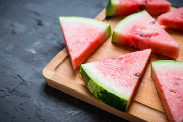 Watermelon slices on the rustic wooden background. Shallow depth of field.