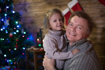 Dad and daughter at the Christmas tree
