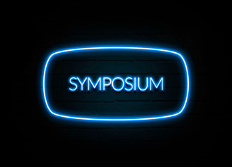Symposium  - colorful Neon Sign on brickwall
