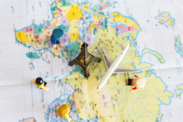 Fototapeta na wymiar top view Miniature Group traveler with backpack standing on wold map for travel around the world. Travel Concept.