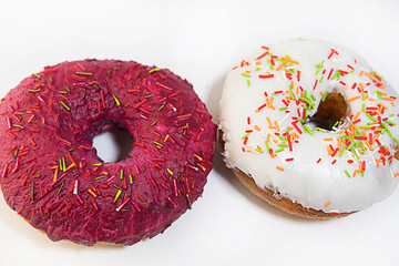 two donuts covered with red glaze top view on white background