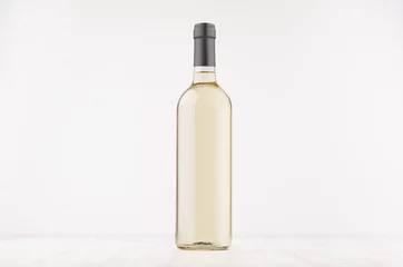 Foto op Canvas Transparent wine bottle with white wine on white wooden board, mock up. Template for advertising, design, branding identity. © finepoints