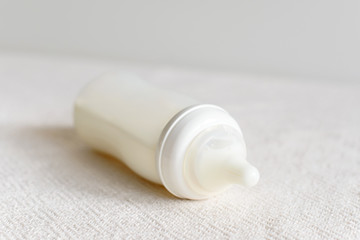 Bottle of milk for baby over blurred background