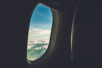 Beautiful nature scenery looking through open window of the airplane from the cabin