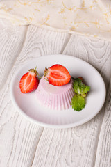 Panna cotta with blueberries jam and strawberries