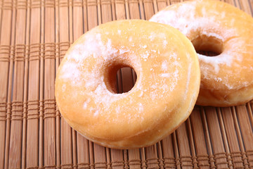 Homemade Doughnuts with Jelly filled and powdered sugar on Bamboo tablecloth. Selective focus.