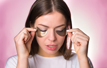 Woman with hydrogel eye patches