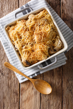American food: tetrazzini with spaghetti, mushrooms, cheese, chicken close-up. Vertical top view