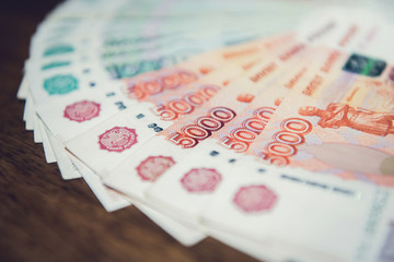 Close up of money, Russian rubble currency banknotes, on wood table