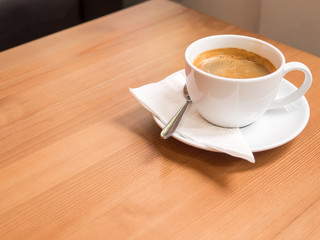 americano coffee  with freshly brewed coffee, on wood table, with white napkin