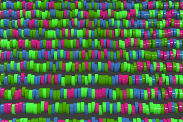 Pattern of blue, red and green cylinder tablets on black background