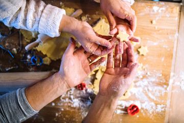 Young family making cookies at home.