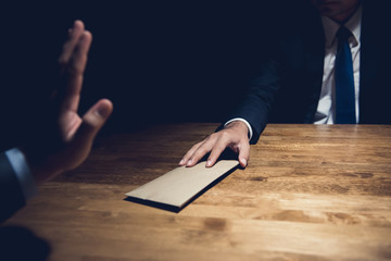 Businessman rejecting money in the envelope