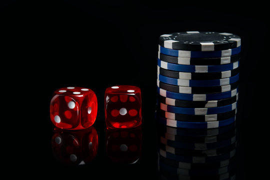 on a black background, two red dice and a bet for the game