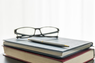 Glasses and book on the desk