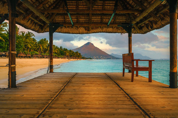 Wonderful view across the pier, on the left the tropical beach and in the background a beautiful...