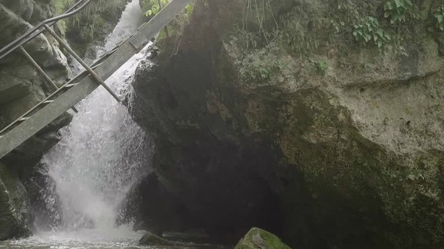 View of waterfall through ledder bridge