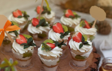 Cup Desert with Cream and Strawberries and Mint. Party candy bar.