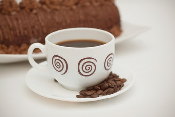 Cup of Coffee with Chocolate Cake on White Table. close Up. Isolated Dessert.
