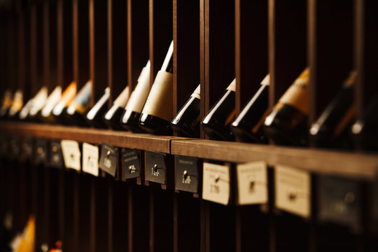Wine cellar with elite drinks on shelves with written names