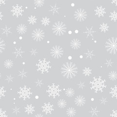 seamless pattern from white snowflakes on the grey background. Texture for cards, greeting, Christmas, new year, holiday, party